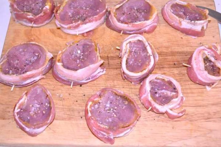 Season Cut bacon-wrapped pork medallions seasoned with sea salt and cracked black pepper before cooking.