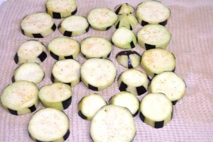 Eggplant Draining eggplant slices on the kitchen towel before frying.
