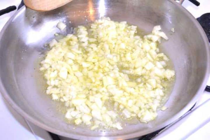 Onion Diced yellow onions gently sautéing in olive oil in a wide frying pan until translucent.