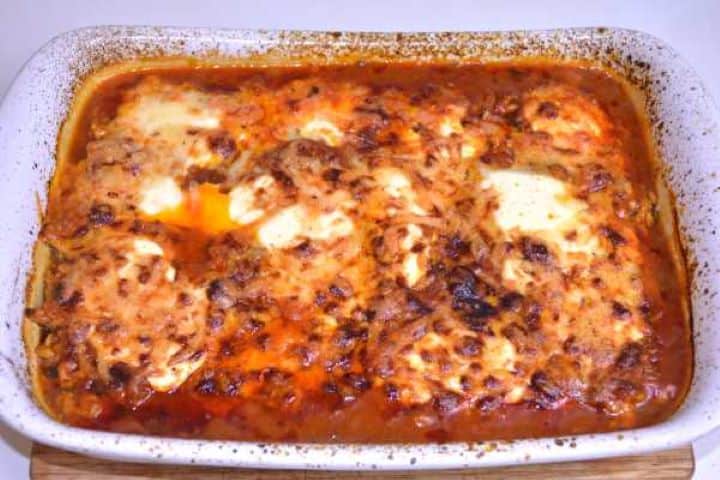 Ready Freshly baked Turkish aubergine moussaka with a bubbling, golden-brown melted Manchego cheese crust.