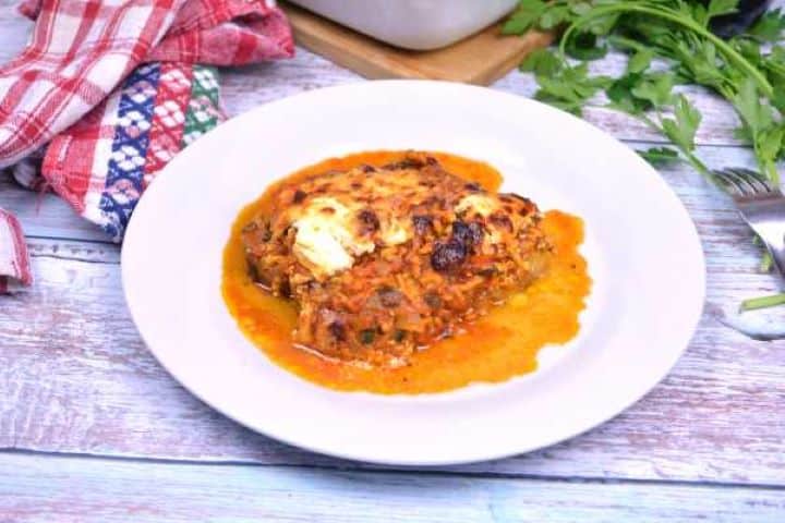 Plated portion of authentic Turkish moussaka showing layered tender aubergines, spiced meat sauce, and baked golden cheese crust.