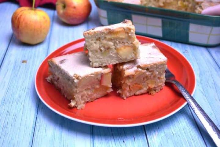 Easy apple cake bars served on red plate.