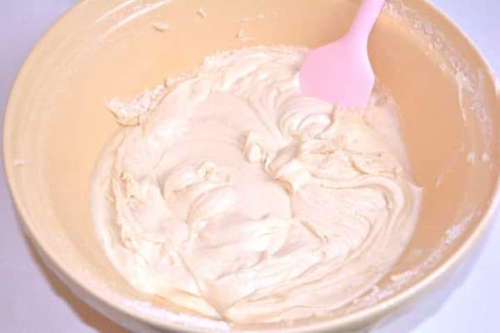 Smooth, thick sponge cake batter mixed in a bowl before folding in the fruit.