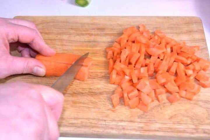 Carrots Cut in Cubes on the Chopping Board