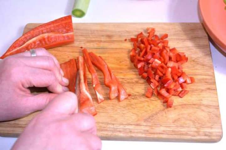 Red Pepper Cut in Cubes on the Chopping Board