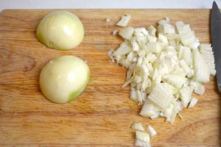 Finely chopped yellow onions prepared as the flavorful base for the turkey paprikash recipe.