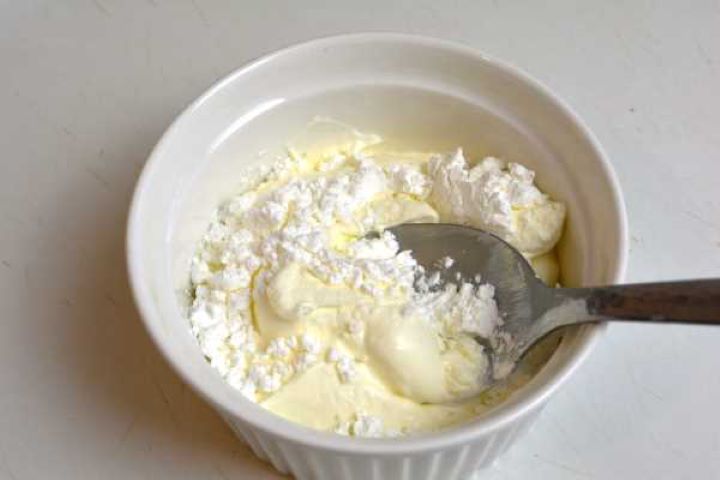 Whisking cornstarch and double cream in a small bowl to create the velvety thickening liaison for the paprikash sauce.