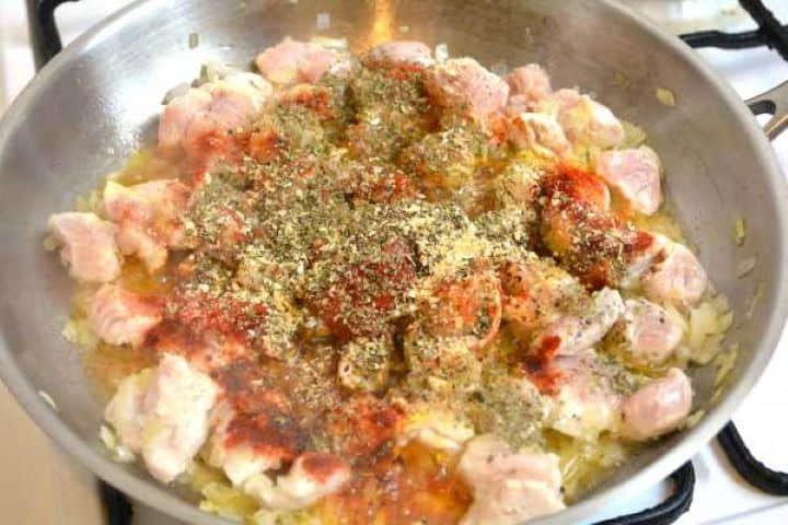 Turkey breast and onions seasoned with salt, pepper, sweet Hungarian paprika, dried marjoram, and tomato paste before mixing.