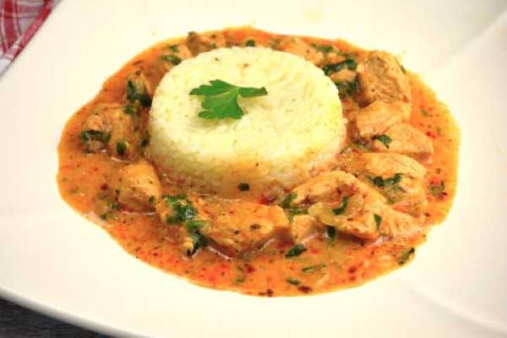 A comforting plate of easy turkey paprikash and steamed rice, showing the velvety texture of the sauce.