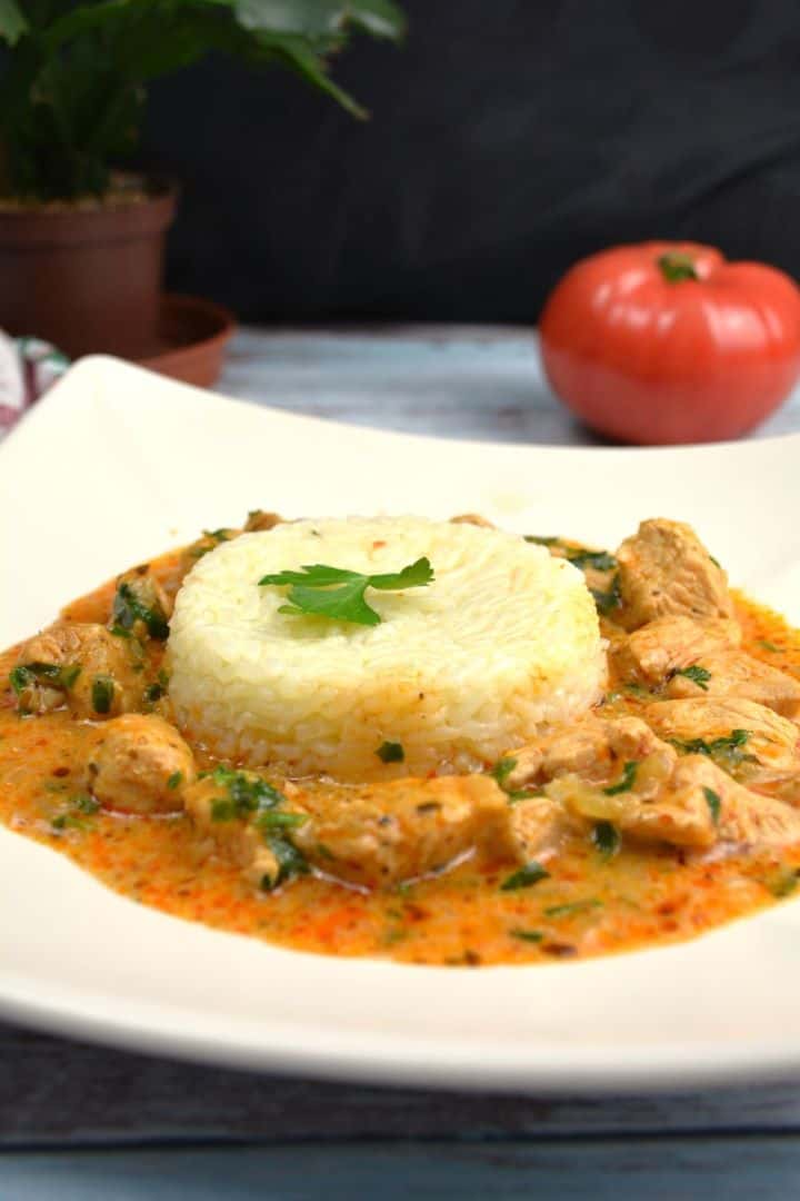 Creamy Hungarian turkey paprikash recipe served on a white plate over fluffy white rice.