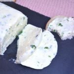 Herbed Cream Cheese-Sliced and Served on Black Tray With Bread