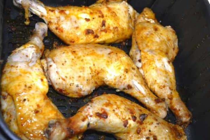 half-fried Flipping the marinated chicken leg quarters skin-side up halfway through the air frying process.