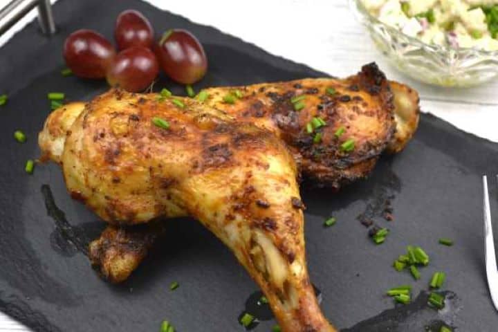 served Two Air Fryer Whole Chicken Legs Served on Black Platter