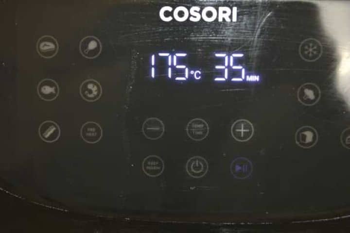 setting Setting the temperature to 347 degrees Fahrenheit on a digital Cosori XXL air fryer panel for cooking chicken leg quarters.