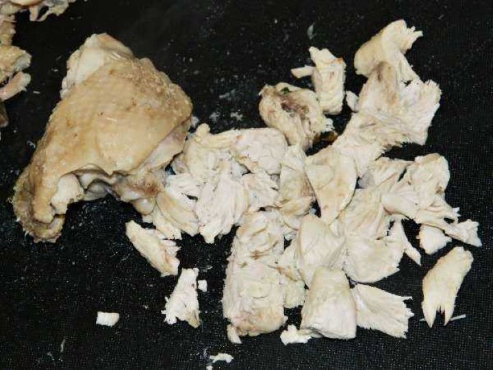 Boiled Chicken Meat Cut in to Pieces on the Chopping Board