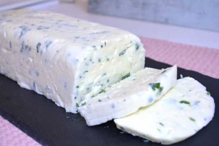 served Homemade herbed cream cheese sliced and served on black tray.