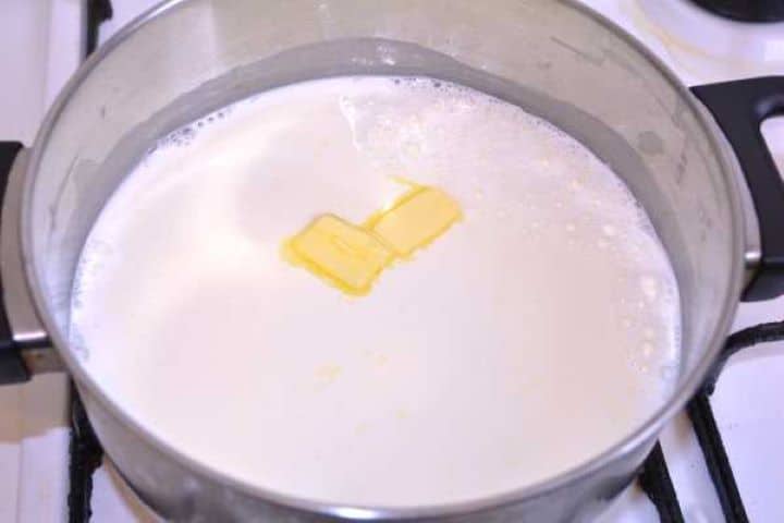 milk Heating milk, sea salt, and butter in a saucepan on the stovetop for the cheese spread base.