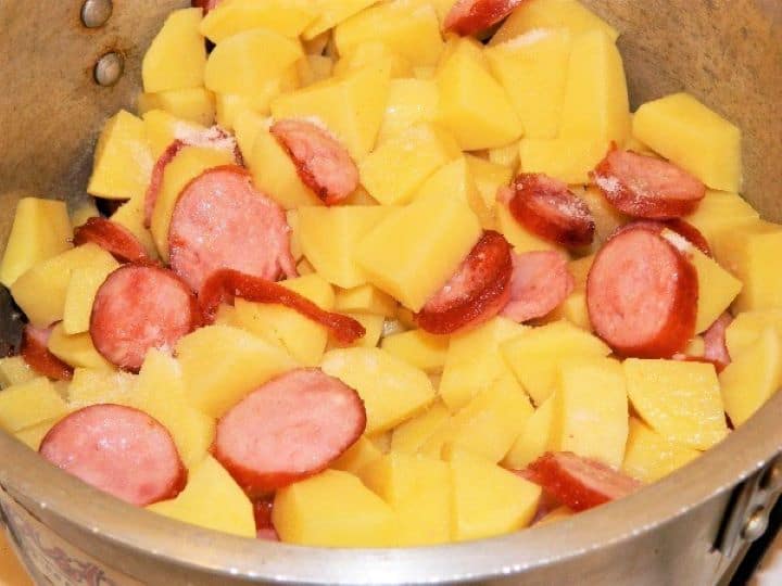 Potatoes and fried sausage Cut Potatoes and Fried Sausage in the Pot