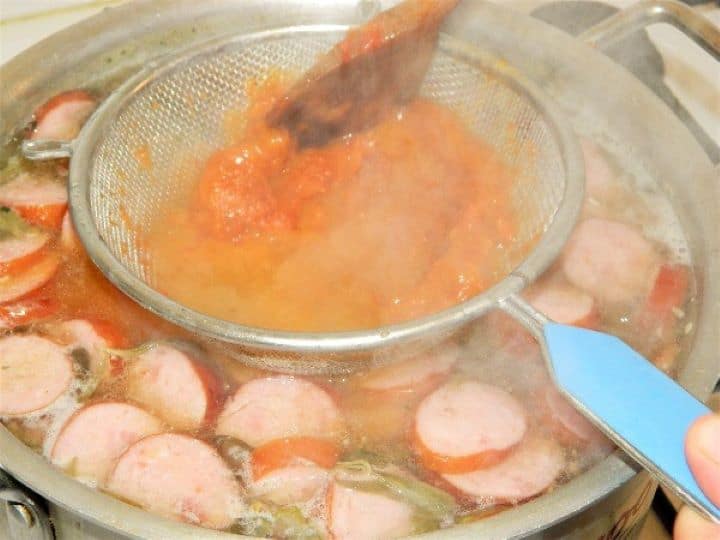 Pour the roux in the potato soup Straining the Roux in the Soup in the Pot