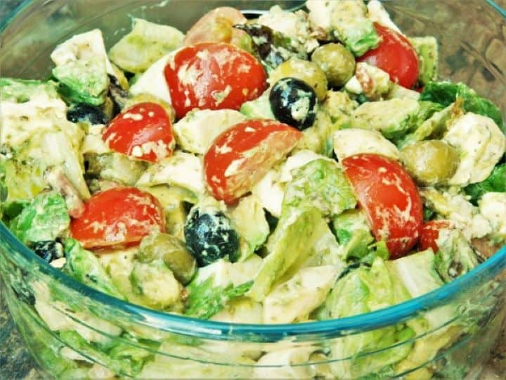 Fresh tomato avocado egg salad with feta cheese and hard-boiled eggs in a bowl.