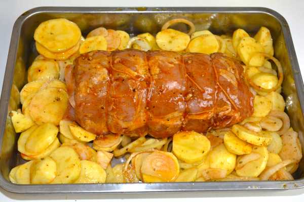 Ham and Cheese Stuffed Pork Loin-Stuffed Pork Loin in the Roasting Tray With Potatoes and Onion