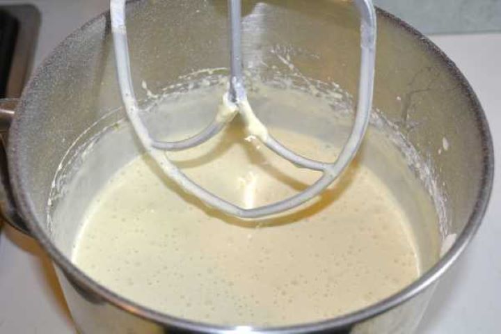Whisking free-range eggs and double cream into the cheesecake batter on low speed.