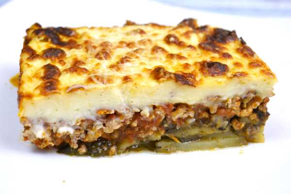Greek Moussaka With Eggplant and Potatoes-Moussaka Slice Served on White Plate