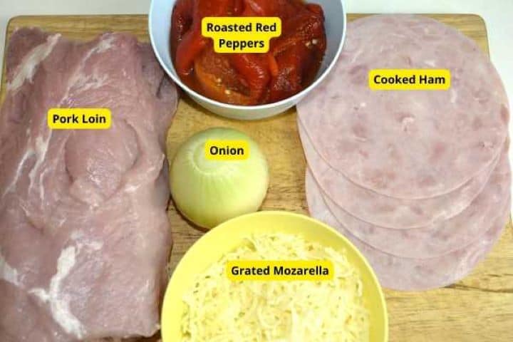 Ingredients for ham and cheese stuffed pork loin including boneless pork roast, smoked ham, mozzarella, and potatoes.