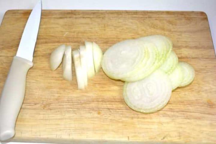 Sliced white onion on the cutting board.