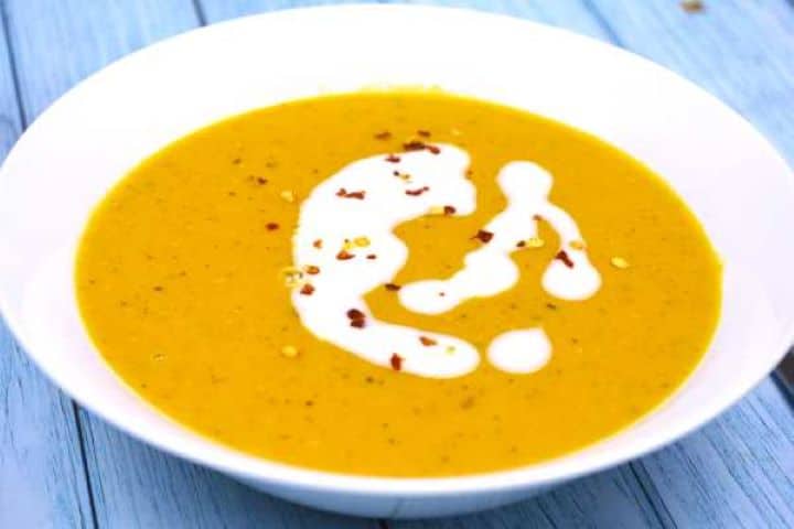 Carrot and lentil soup served in bowl.