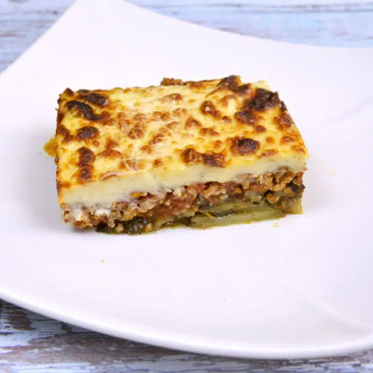 Greek Moussaka With Eggplant and Potatoes-Moussaka Slice Served on White Plate