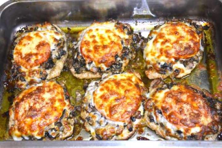 Oven-baked cheesy pork chops with bubbly, golden-brown melted mozzarella cheese.