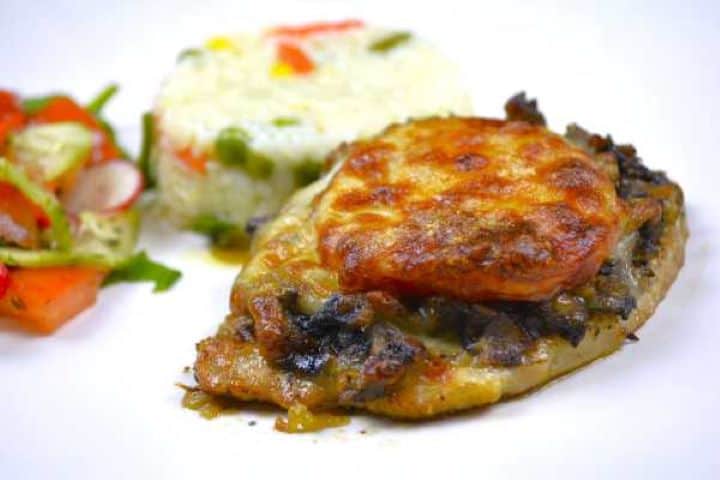 Baked cheesy pork chops served with seasoned rice pilaf and a fresh summer garden salad.