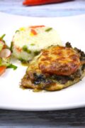 Cheesy Pork Chops-Served on Plate With Rice and Summer Salad
