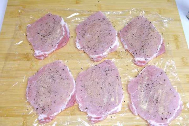 Boneless pork loin chops pounded to 0.5 cm thickness and seasoned with sea salt, pepper, and onion granules.