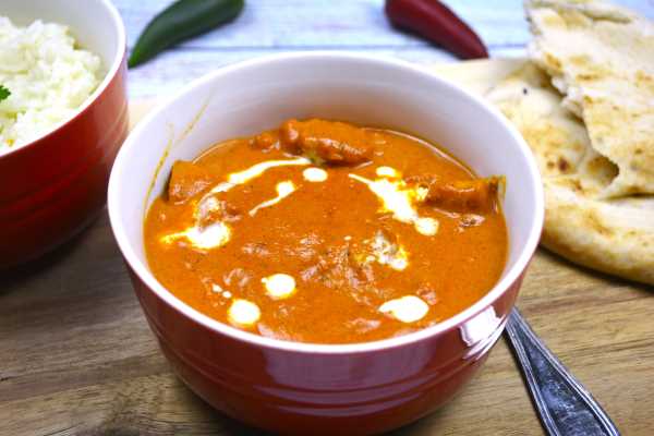 Creamy Butter Chicken-Served in Red Bowl With Naan Bread and Rice