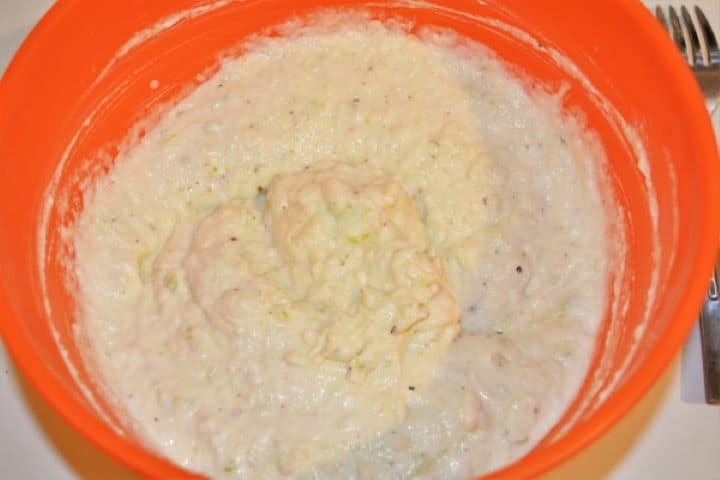 Mixing creamy mayonnaise and English mustard into the seasoned cauliflower puree.