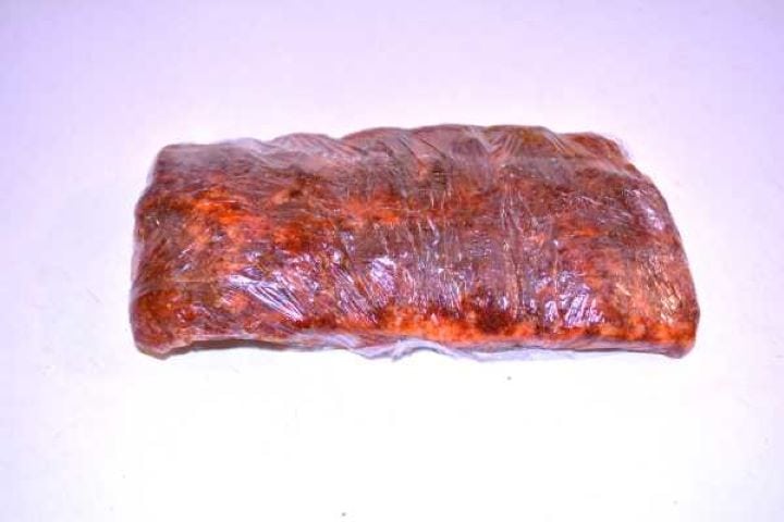 Pork ribs wrapped securely in plastic cling film ready for marinate.