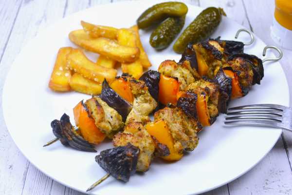 Oven Cooked Chicken Kebabs-Served on White Plate With Fries