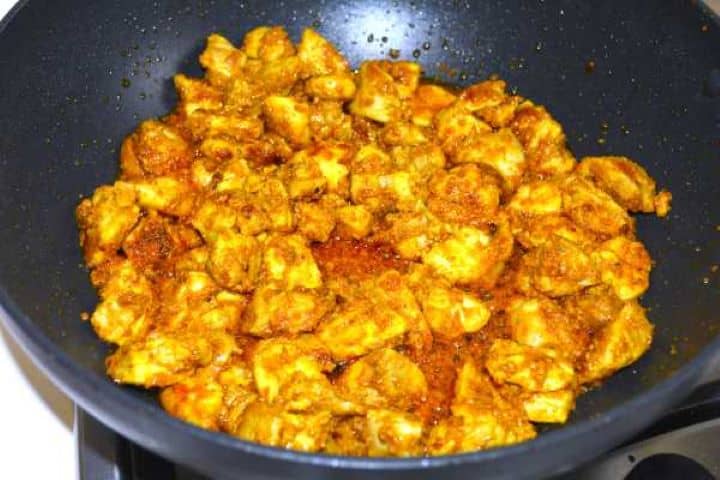 Seared marinated chicken thighs in the pan.