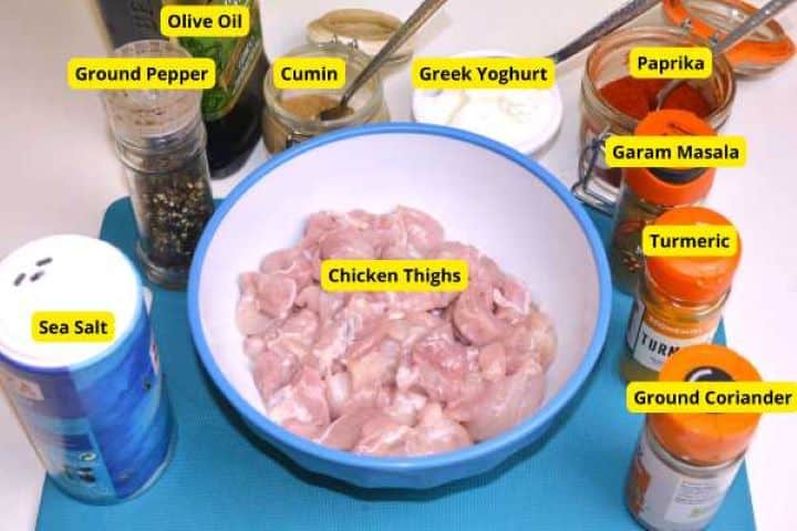 Ingredients for easy butter chicken including chicken thighs, spices, tomato passata, heavy cream, and butter.