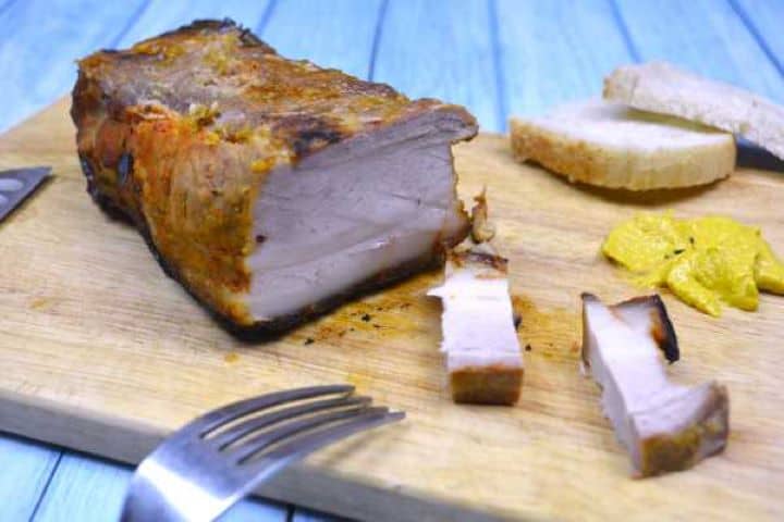 Sticky honey glazed pork belly cubes served as appetizers with mustard dip.