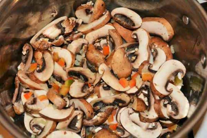 Best Mushroom Soup Recipe-Frying Sliced Mushrooms, Chopped Onions and Bell Pepper in the Pot Sautéing sliced chestnut mushrooms, wild porcini, sweet Hungarian paprika, and fresh thyme.