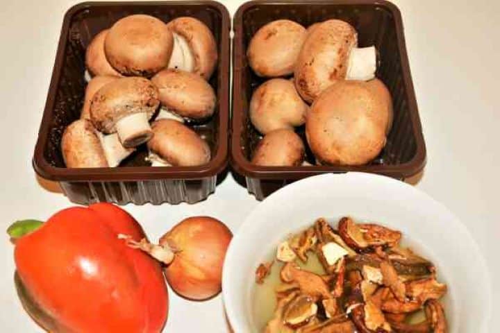 Best Mushroom Soup Recipe-Ingredients Fresh ingredients for Hungarian mushroom soup including chestnut mushrooms, dried porcini, sweet paprika, and red pepper.
