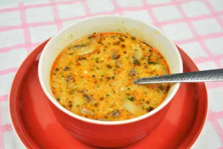 Best Mushroom Soup Recipe-Served in Bowl Steaming bowl of Hungarian mushroom soup garnished with a dollop of sour cream and fresh parsley.