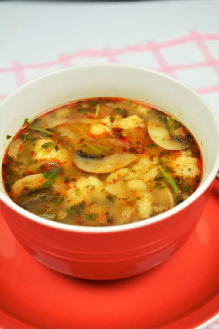 Best Mushroom Soup Recipe-Served in Bowl Cozy red bowl of authentic Hungarian mushroom soup with homemade nokedli dumplings and fresh parsley.