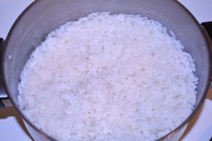 Layered Sauerkraut Casserole-Cooked Rice in the Pot Tender cooked white rice resting in a saucepan with all water absorbed.