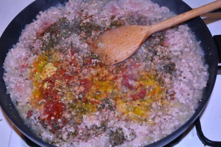 Layered Sauerkraut Casserole-Frying Seasoned Pork Mince and Onions in the Pan Seasoning ground pork with Hungarian sweet paprika, tomato paste, marjoram, and caraway.
