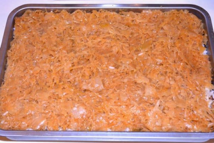 Layered Sauerkraut Casserole-Sauerkraut is the Fifth Layer in the Baking Dish Covering the rice with the final top layer of cooked shredded sauerkraut.