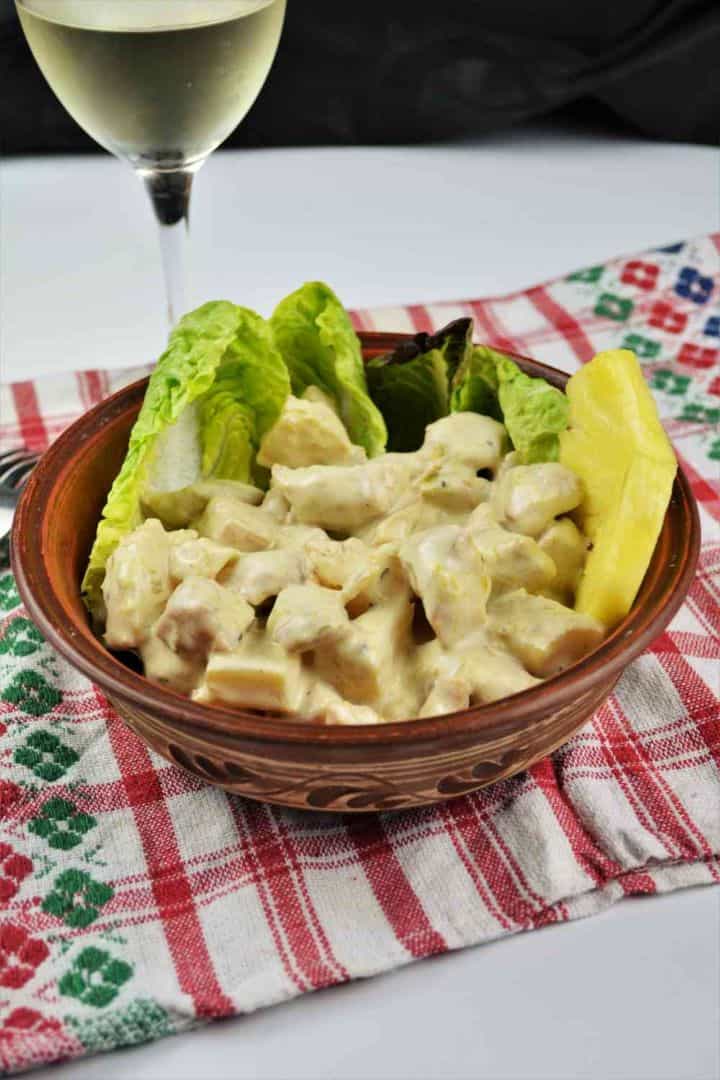 Chicken Breast With Pineapple-Served in Bowl Garnished With Lettuce and Pineapple Slices Creamy chicken breast with pineapple salad served in a ceramic bowl garnished with fresh lettuce leaves and sweet pineapple chunks.